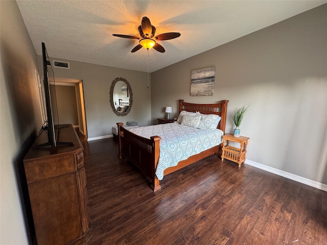 bedroom featuring baseboards, visible vents, ceiling fan, wood finished floors, and a textured ceiling