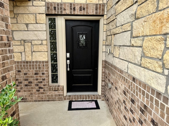 entrance to property with brick siding