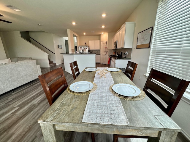 dining space with stairs, wood finished floors, visible vents, and recessed lighting