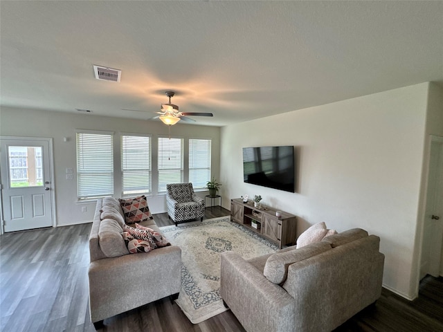 living room featuring visible vents, ceiling fan, and wood finished floors