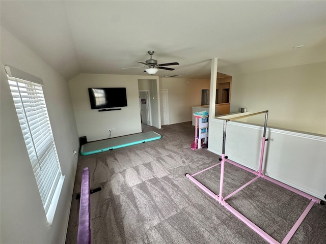 interior space with carpet, vaulted ceiling, and ceiling fan