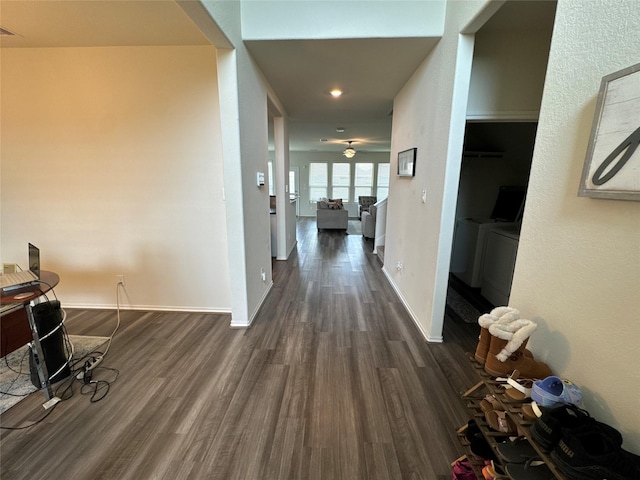 hall featuring dark wood-style floors, visible vents, and baseboards