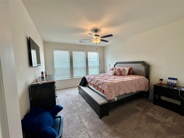 carpeted bedroom with a ceiling fan and visible vents