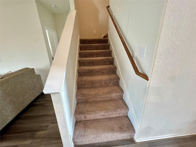 stairway with wood finished floors