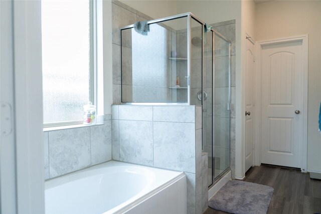 18802 Verdura Dr, New Caney, TX 77357 - full bath with wood finished floors, a garden tub, and a shower stall