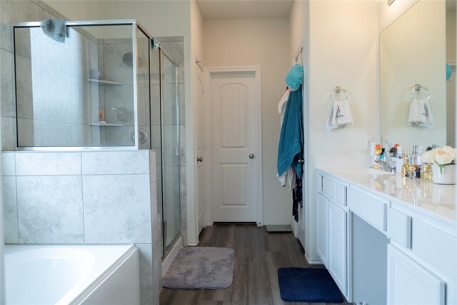 18802 Verdura Dr, New Caney, TX 77357 - bathroom with a stall shower, a bath, wood finished floors, and vanity