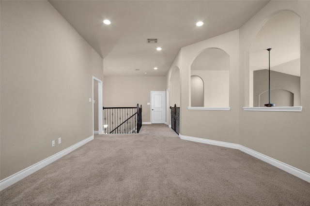 unfurnished room featuring baseboards, visible vents, carpet flooring, and recessed lighting