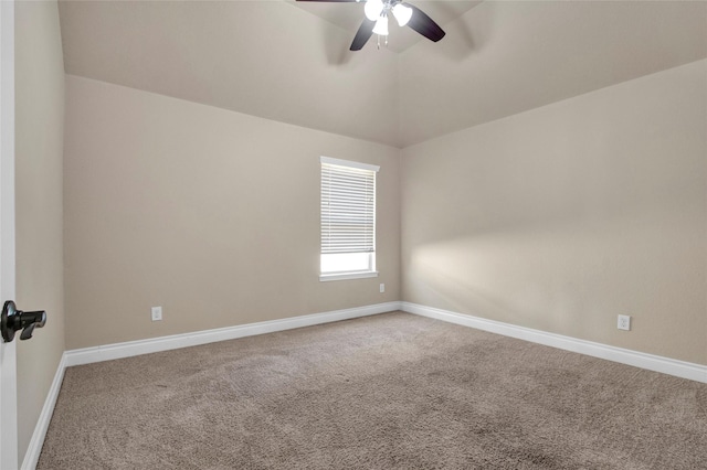 carpeted spare room featuring ceiling fan, baseboards, and vaulted ceiling