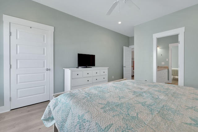 bedroom with connected bathroom, baseboards, ceiling fan, and light wood finished floors