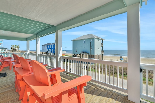 deck with a water view and a beach view