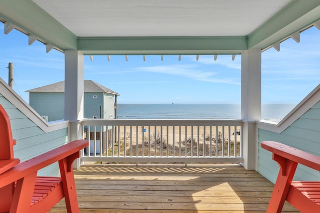 deck with a view of the beach and a water view