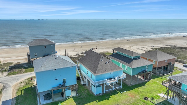 drone / aerial view with a water view and a view of the beach