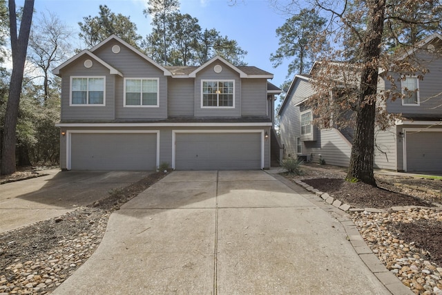 traditional-style home featuring an attached garage and driveway