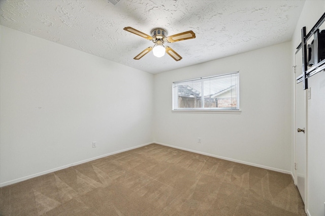 unfurnished bedroom featuring baseboards, light colored carpet, and a textured ceiling