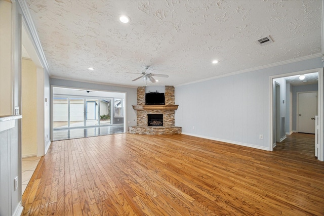unfurnished living room featuring crown molding, light wood-style flooring, and a fireplace