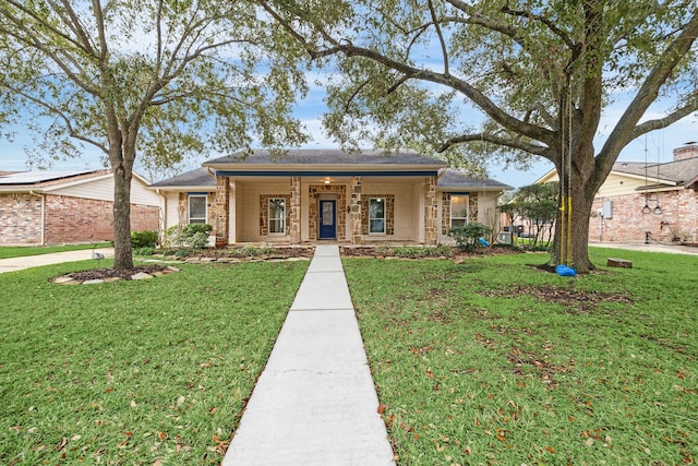 view of front facade with brick siding, a porch, and a front lawn