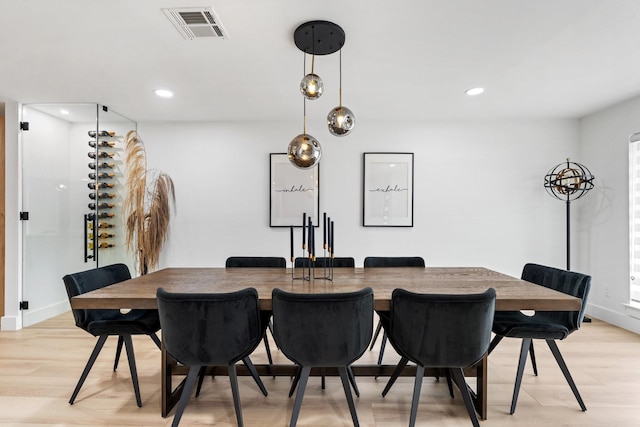 dining space with baseboards, light wood finished floors, visible vents, and recessed lighting