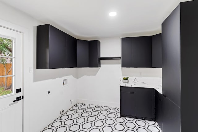 laundry area with a healthy amount of sunlight, cabinet space, washer hookup, and electric dryer hookup