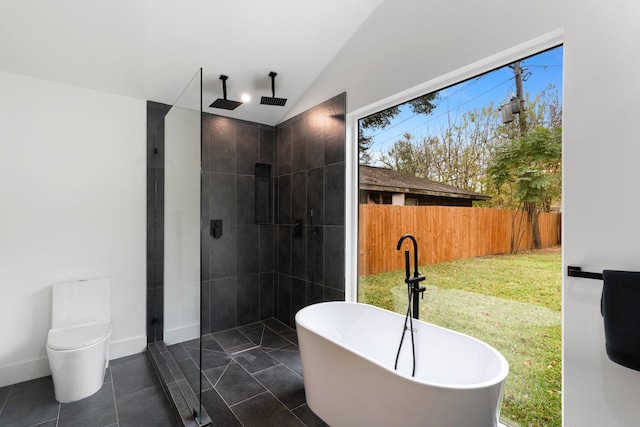 bathroom with lofted ceiling, tile patterned flooring, a tile shower, and a freestanding bath