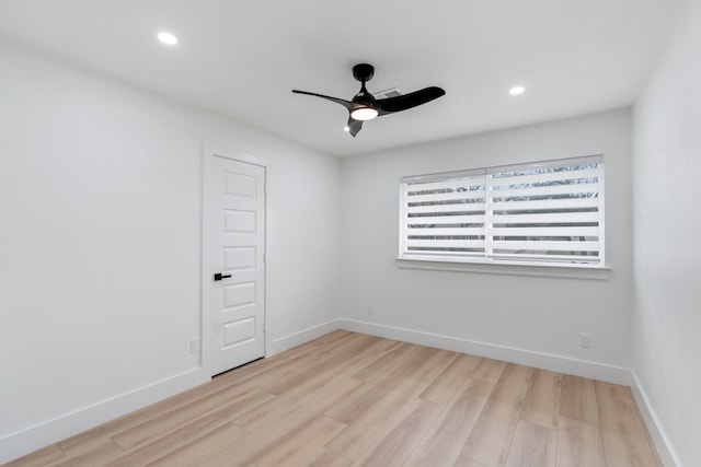 spare room featuring a ceiling fan, recessed lighting, baseboards, and light wood finished floors