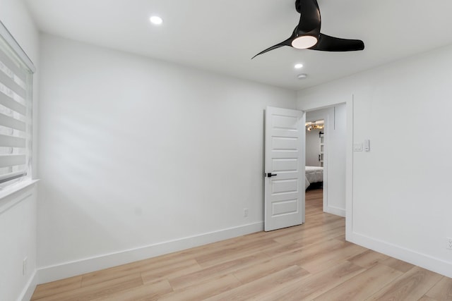 unfurnished bedroom with light wood finished floors, recessed lighting, and baseboards