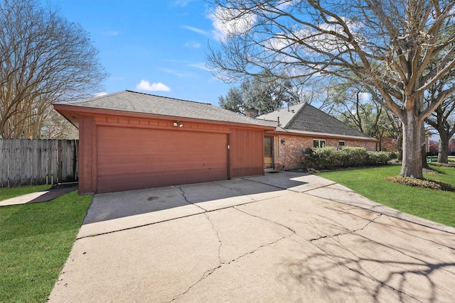 view of front of property with a garage, concrete driveway, a front lawn, and fence