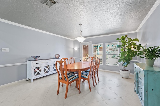 dining space with ornamental molding, visible vents, baseboards, and light tile patterned flooring