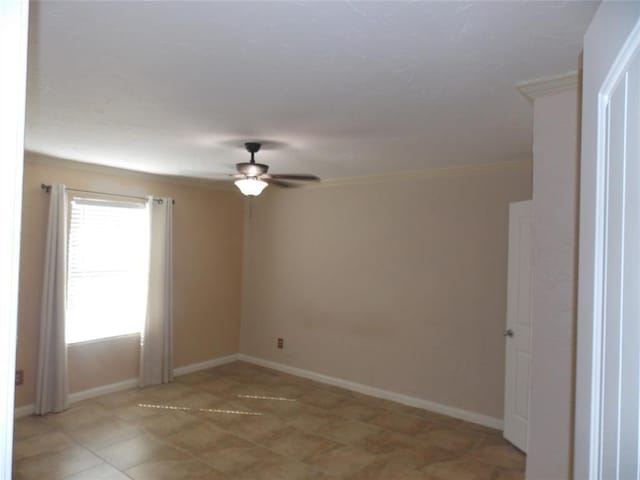 spare room featuring ceiling fan and baseboards