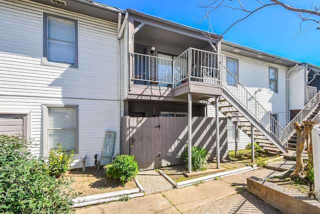 rear view of property with stairway