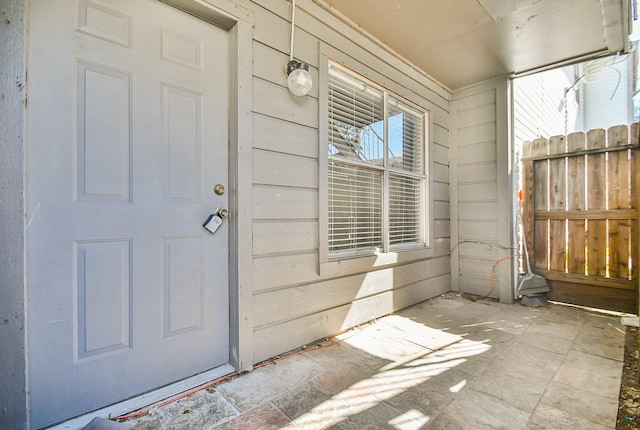 doorway to property with fence