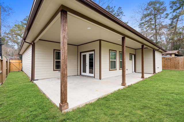 rear view of property with a patio, a yard, and a fenced backyard