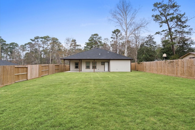 rear view of property featuring a patio area, a fenced backyard, and a lawn