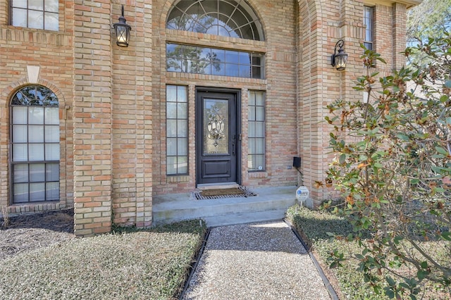 property entrance featuring brick siding