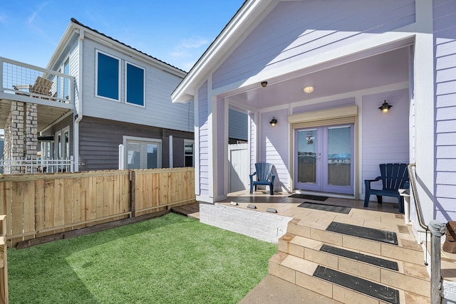 exterior space featuring a yard, french doors, and fence