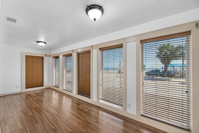 interior space with visible vents and wood finished floors