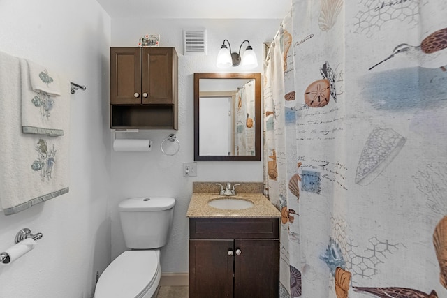 bathroom featuring toilet, curtained shower, vanity, and visible vents