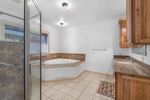 full bath with a stall shower, vanity, a bath, and tile patterned floors