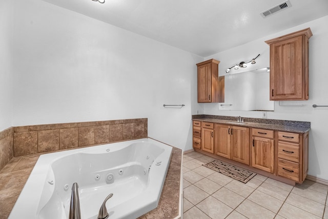 full bath with tile patterned floors, a tub with jets, visible vents, and vanity