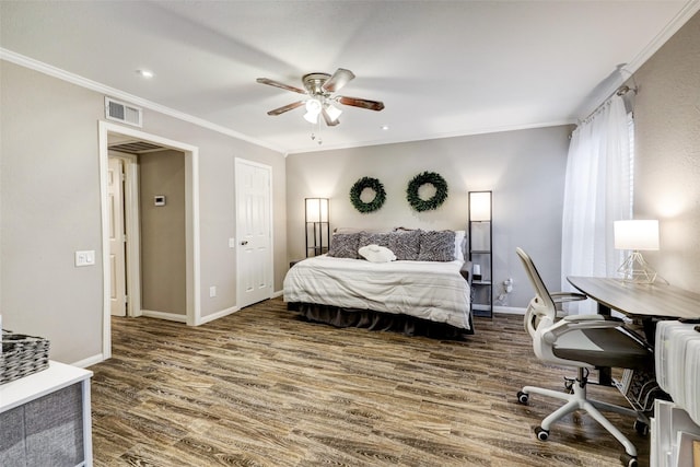 bedroom with ceiling fan, wood finished floors, visible vents, baseboards, and ornamental molding