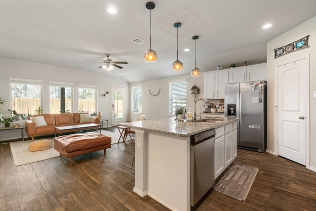 kitchen featuring stainless steel appliances, a sink, visible vents, white cabinetry, and dark wood-style floors