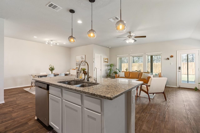 kitchen with open floor plan, visible vents, a sink, and dishwasher