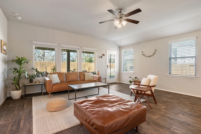 living area with ceiling fan, vaulted ceiling, baseboards, and wood finished floors