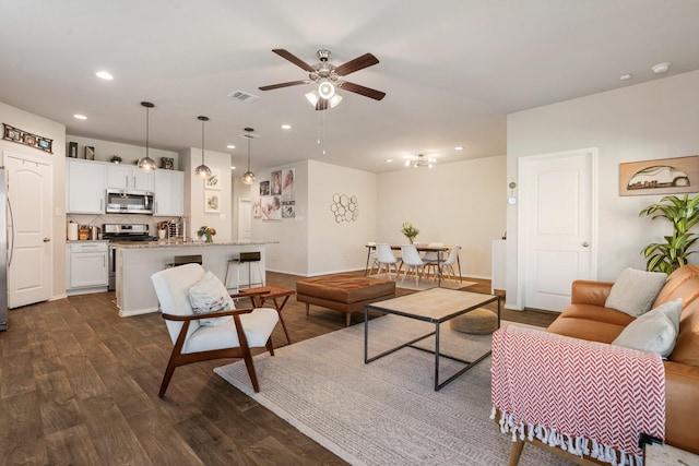 living area with visible vents, dark wood finished floors, a ceiling fan, and recessed lighting