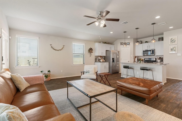 living room featuring ceiling fan, dark wood-type flooring, visible vents, and recessed lighting