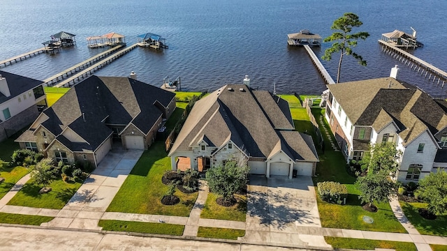 drone / aerial view featuring a water view and a residential view