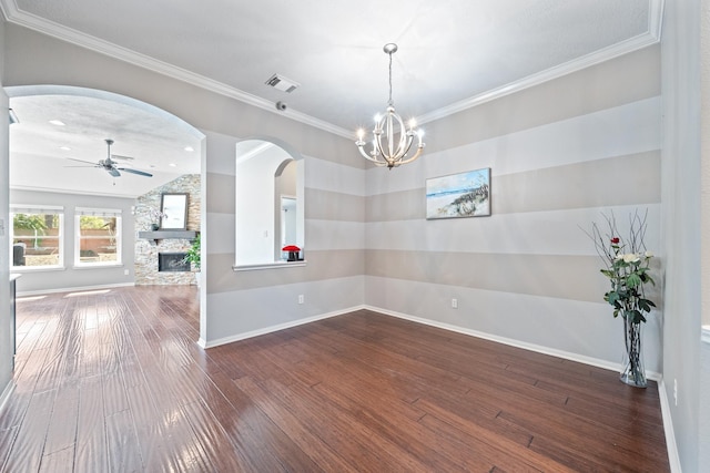 unfurnished room with visible vents, a fireplace, ceiling fan, ornamental molding, and hardwood / wood-style flooring