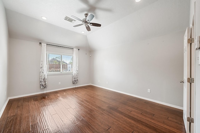 spare room featuring lofted ceiling, wood finished floors, visible vents, and baseboards