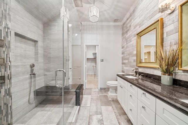 full bathroom with toilet, ornamental molding, a sink, a shower stall, and double vanity