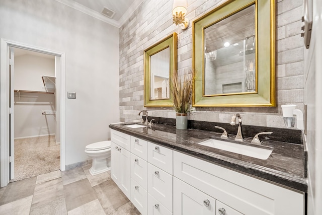 bathroom with visible vents, toilet, crown molding, and a sink