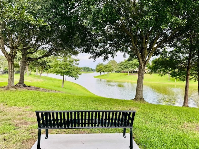 surrounding community featuring a yard and a water view